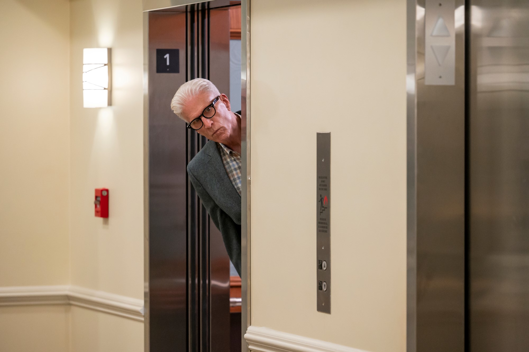 Ted Danson as Charles, peering out of an elevator in 'A Man on the Inside'